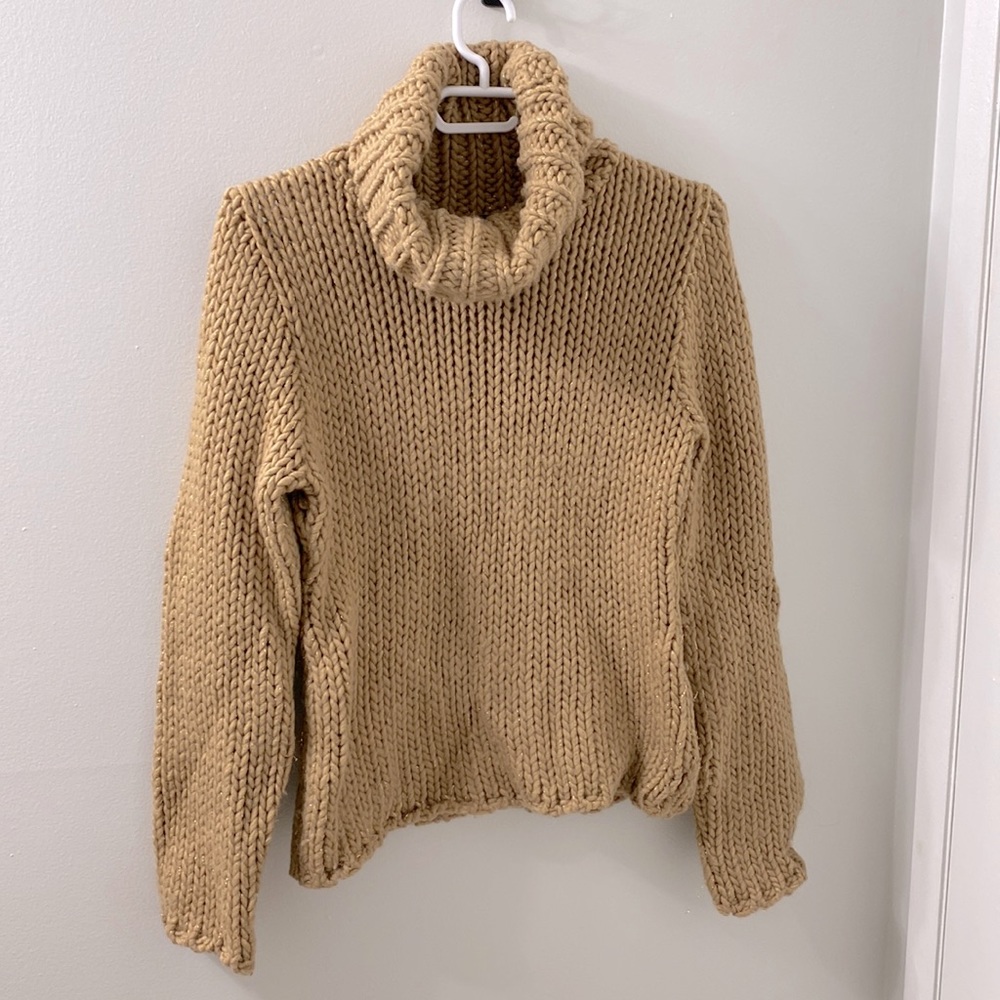 This is made of acrylic, wool, and polyester. This is a Morgan de toi sweater.